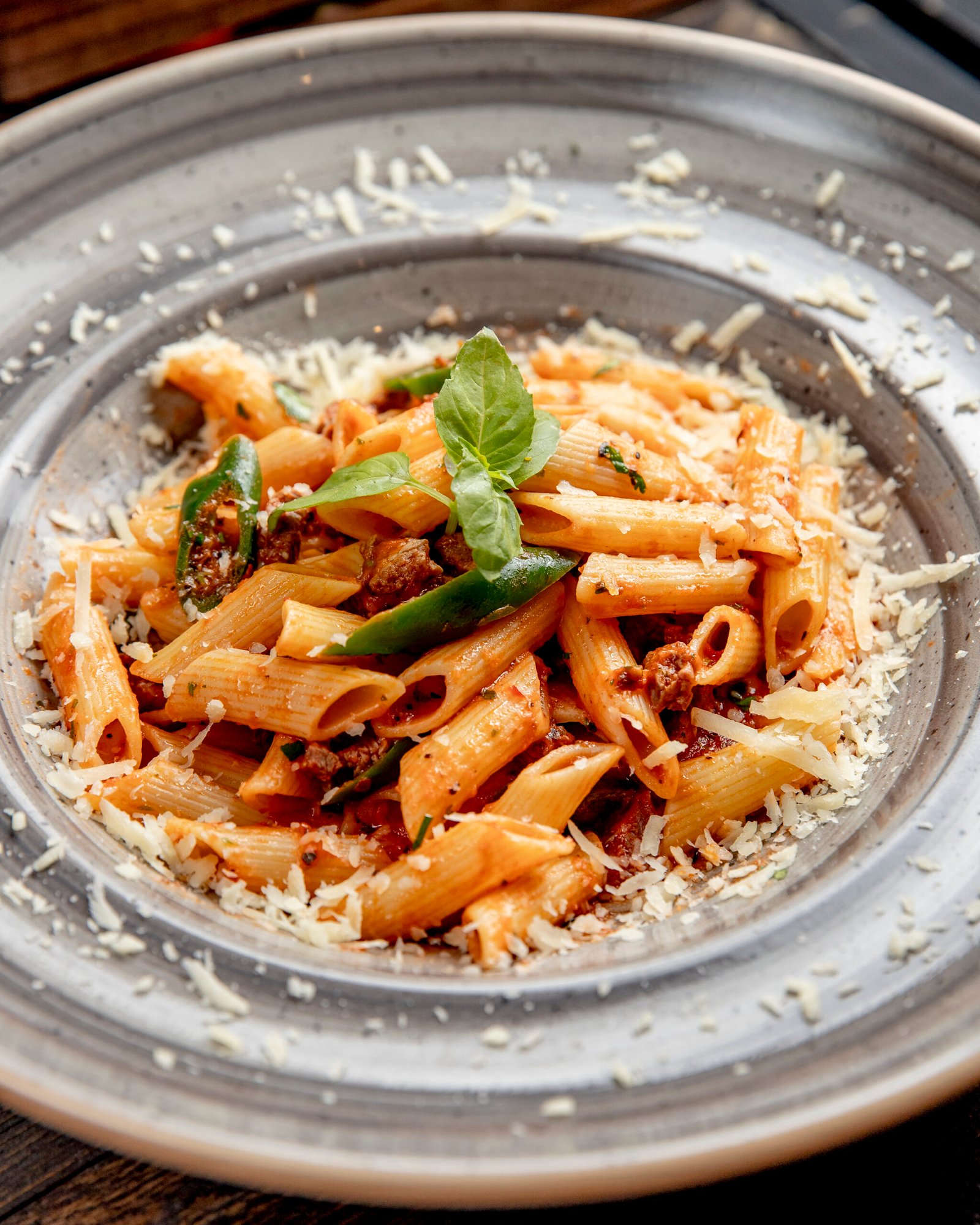pasta with meat grated cheese and basil leaf